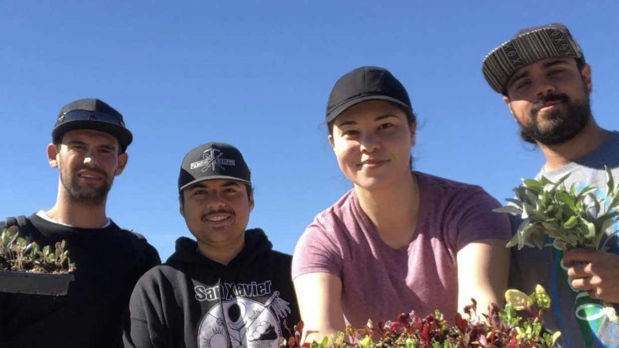 People holding produce from a garden.