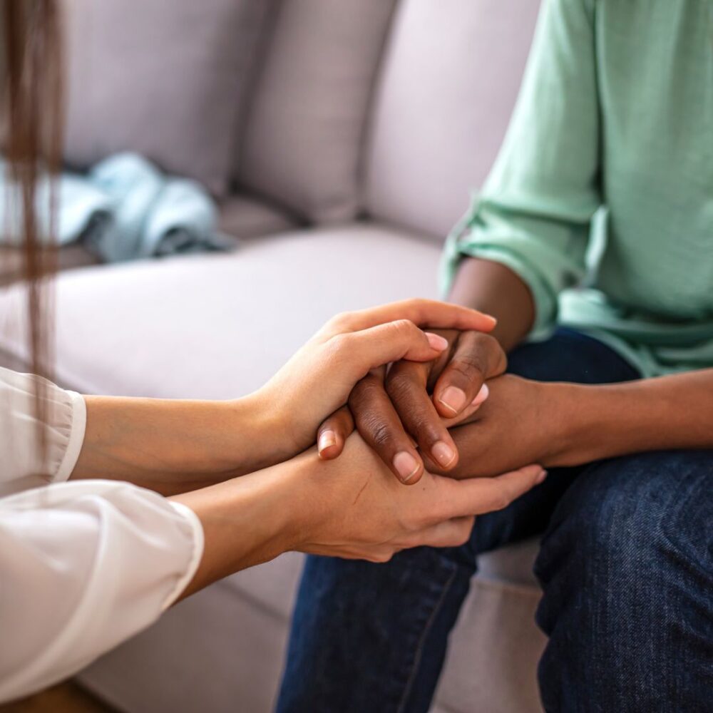 Two people holding hands