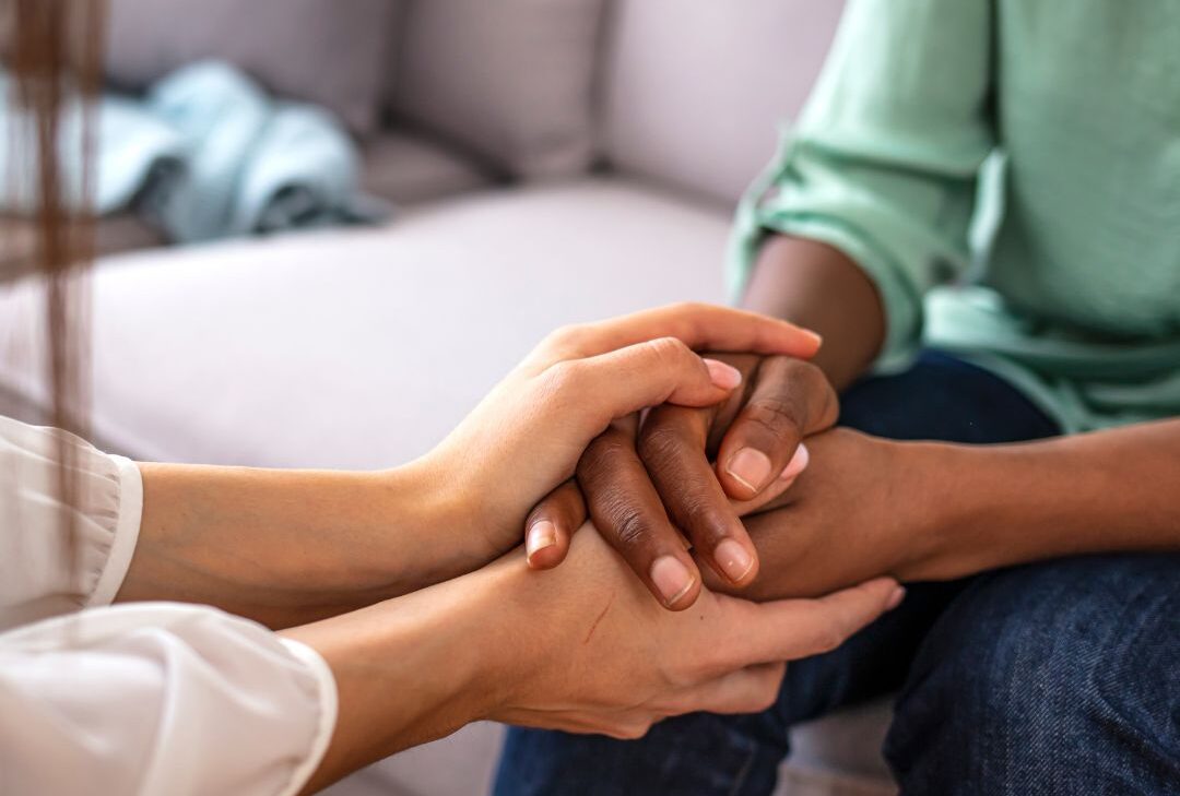 Two people holding hands