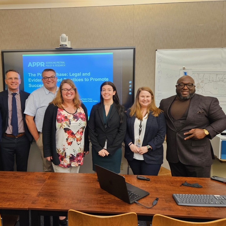 Six people standing and smiling.