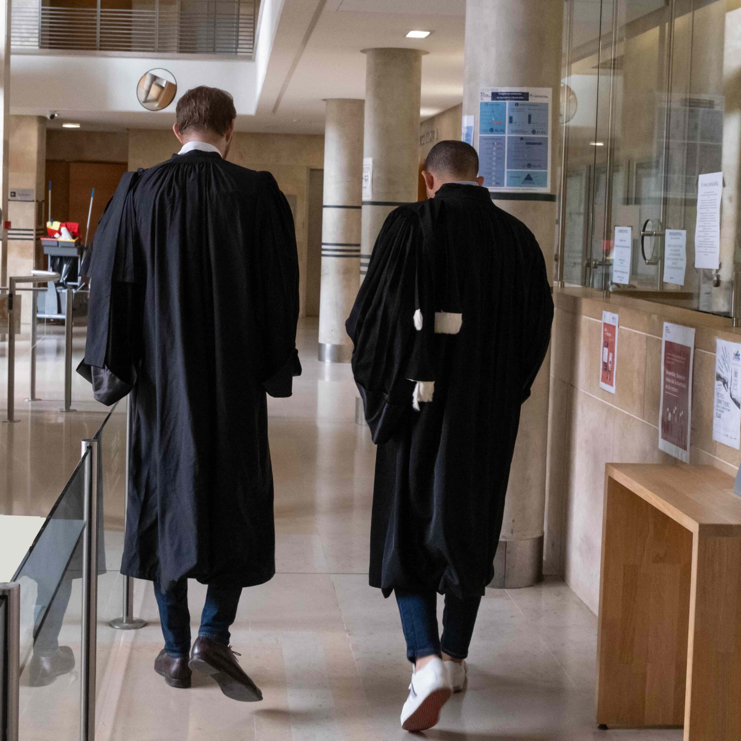 Two judges walking through a corridor